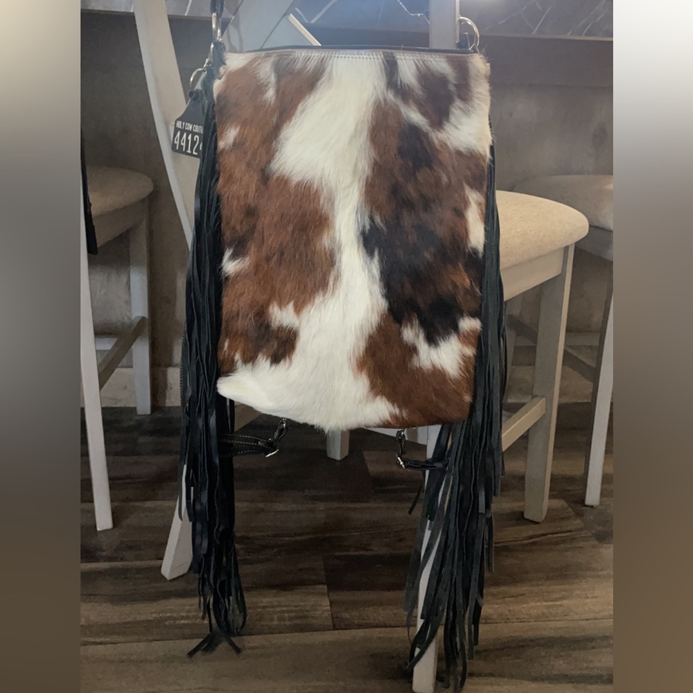 Cow print, real leather and authentic hide with a concealed compartment!